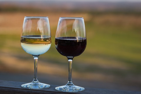 white and red wine in glasses outside at Blenheim vineyards. Grettig photo