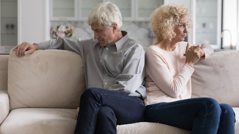 A couple sitting on a sofa looking away from each other during an argument. Images by Fizkes. Article on a wife who won't stop flirting with another man