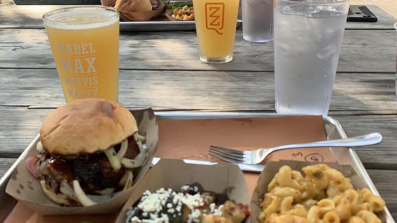 ZZQ BBQ sandwich, sides, and beer. ZZQ is one of the top Richmond restaurants covered in "100 Things to Do in Richmond Before You Die," by Annie Tobey