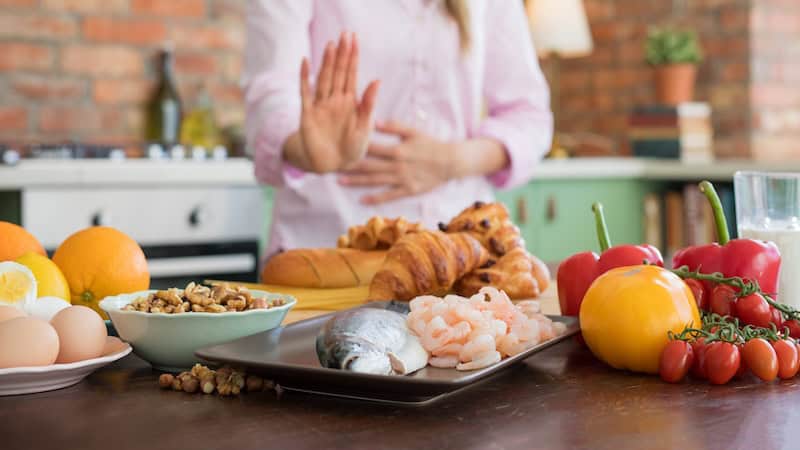 A woman rejecting foods that she is allergic to. When they eat the wrong foods, this person suffers after. But when they insist on a bland meal on social occasions, they face criticism. Advice columnist Eric Thomas offers suggestions, including food allergy retorts to the critics.