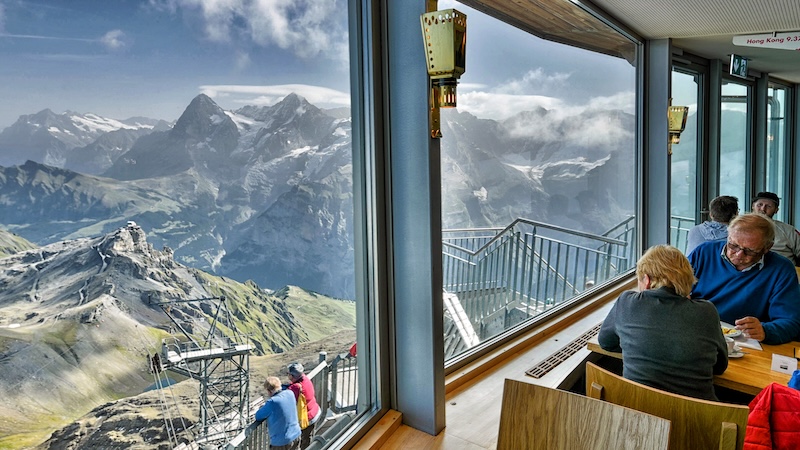 Surrounded by a spectacular Swiss Alps vista, dining atop the nearly 10,000-foot Schilthorn peak is a breathtaking experience. Hiking the Swiss Alps will certainly build up the appetite. (Cameron Hewitt, Rick Steves' Europe)