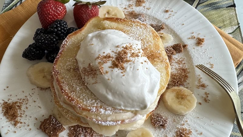 Banana Cream Pie Pancakes - with banana slices, whipped cream and berries on the side