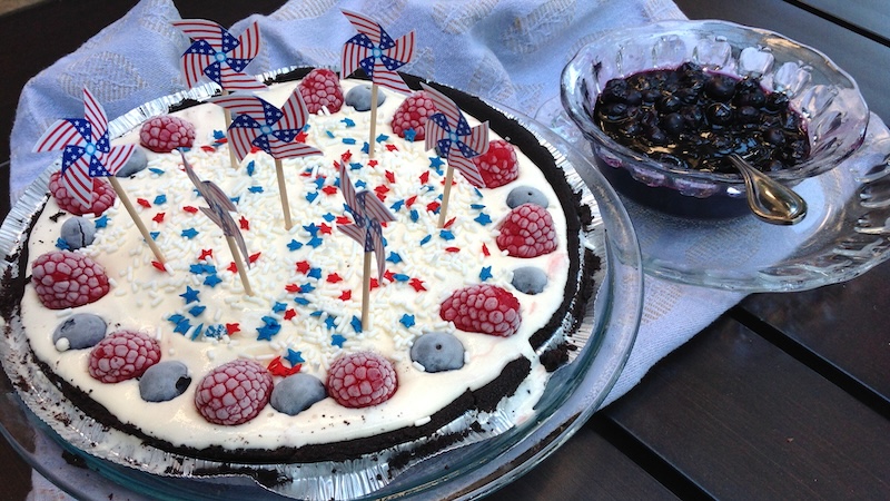 Ice Cream Pie with Blueberry Sauce and berries and patriotic garnishes