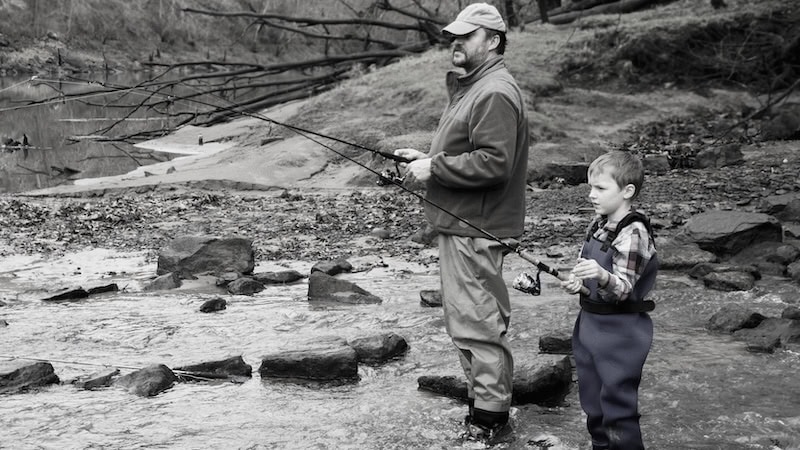 A father and son fly fishing, by Irina Kozhemyakina. Accompany article on memories of his father