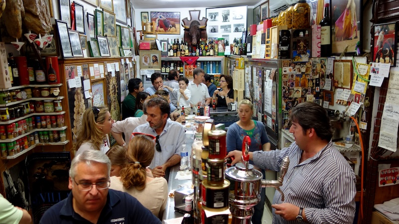 An abacería – part grocery store, part tapas bar – is the ideal place to rub elbows with locals in Sevilla in Andalucía, Spain. CREDIT: Rick Steves, Rick Steves’ Europe