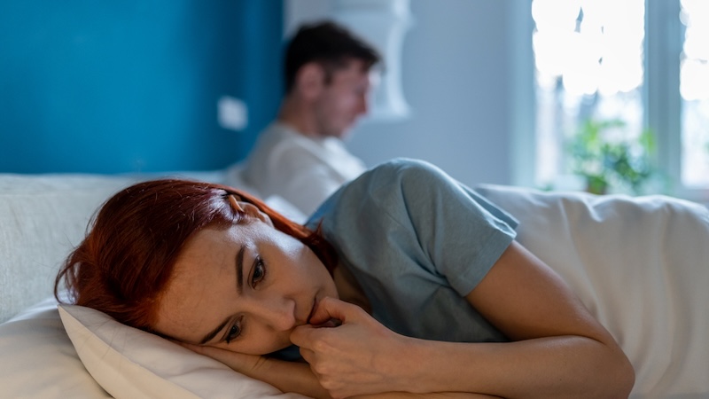 A young woman in bed with her disinterested partner behind her. By Dmitry Marchenko. The mother is concerned about her daughter's abusive boyfriend.