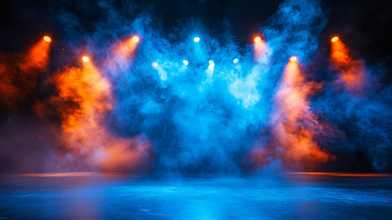 Concerts concept with blue and orange lights filtering through smoke on a stage. AI image from Yana Lysenko. Used with What's Booming, Richmond, Va., July 31 to Aug. 7