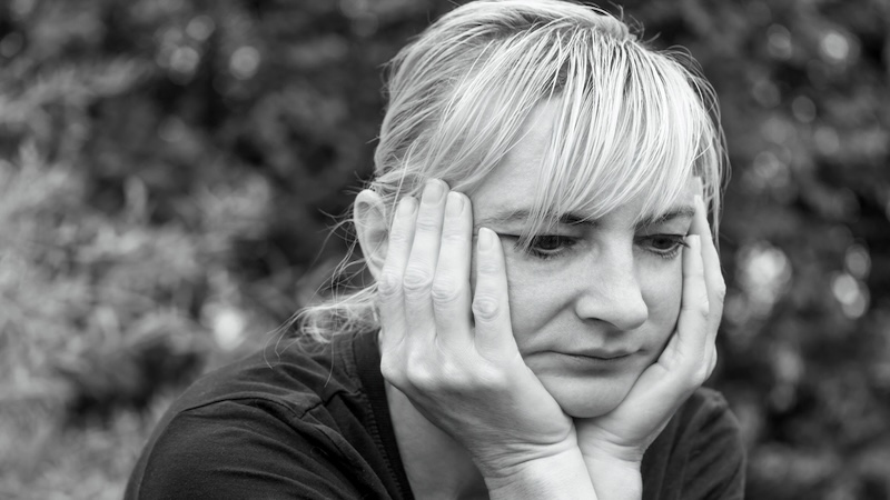 A woman tired, facing emotional exhaustion. Image by Jaroslav Frank.