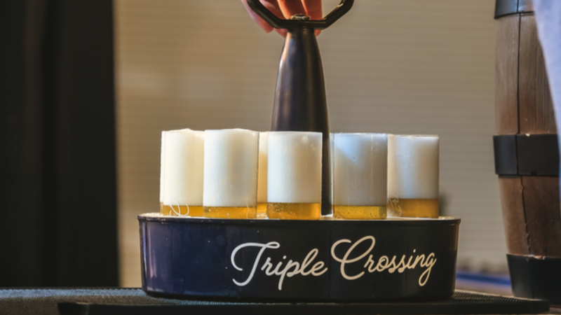 A 'Kranz,' a circular tray holding multiple Stangen of Kölsch-style beer from Triple Crossing Beer, for their Kölsch Fest. Part of What's Booming: Motorbikes and the Bard