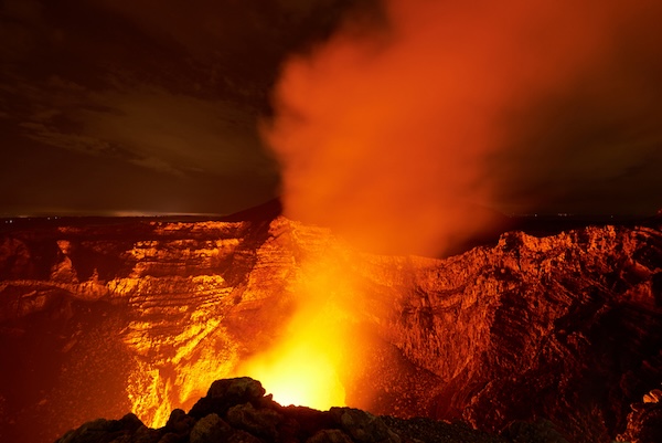 Flames and smoke from a volcano, surrounded by rock walls. For What's Booming July 3