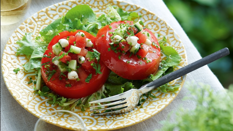 Feta, cucumber and watermelon relish add pizzazz to this summer tomato salad. (Yvonne Duivenvoorden/TCA)