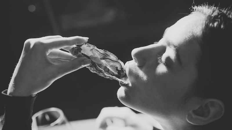 Eating a raw oyster, like Chicken Jack demonstrated. Image by Volodymyr Tverdokhlib