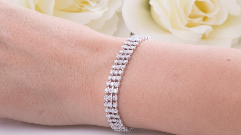 A woman's tennis bracelet, like this one on a woman's arm with white roses in the background, went to an undeserving beneficiary in the will. Image by Nattaputch Techarsititwong