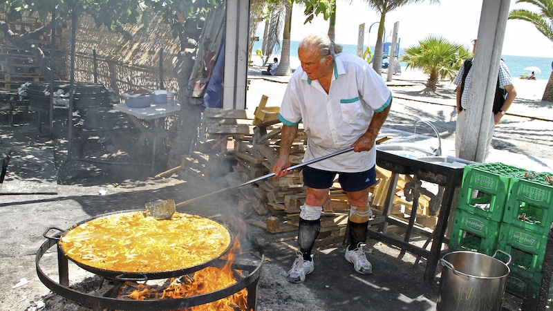 Ayo has been cooking up beachside paella for decades in Nerja, Spain. It is one of Rick Steves' favorite European seaside bars. CREDIT: Rick Steves, Rick Steves’ Europe.