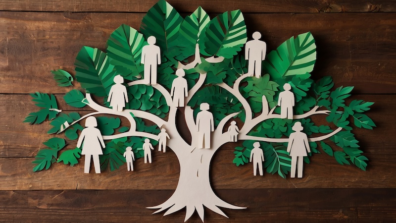 An artsy cut-out of a tree, with people standing throughout the branches, to represent heritage travel.
