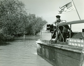 A photo of David Raber on the Mekong Delta in a patrol boat. He was instrumental in the psychological ops campaign that led many Viet Cong to reject guerilla warfare and rejoin the South Vietnamese government. Used in the Vietnam veterans memoir