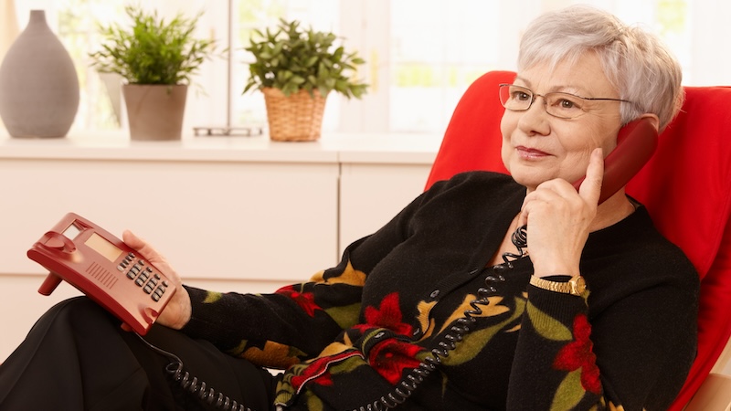 A senior woman on the phone. Used with column on multitasking phone conversations.