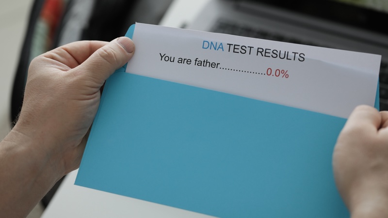 A DNA revelation: a man opens an envelope showing he isn't the father. By Kuprevich