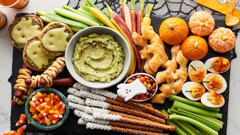 A Halloween snack board with tasty appetizers with seasonal accents.