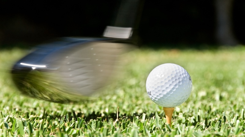 Image of a moving golf club about to hit a golf ball on a tee. Incivility rules at the Ryder Cup 2025