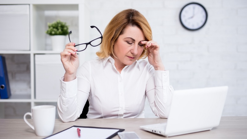 A woman is stressed at work, and all of the sitting doesn't help. She needs these tips on staying active at work. Image by Diana Ellen