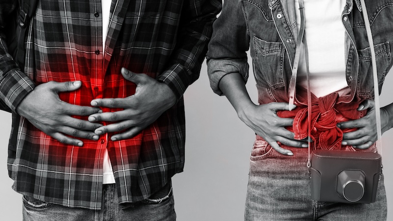 A couple holding their stomachs after getting traveler's diarrhea