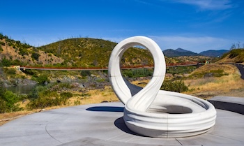 Looking west through the Infinite Journey sculpture at the Sacramento River Trail Bridge - Nick Thomas