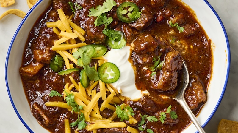 Brisket chili topped with shredded cheese, corn chips, sour cream, jalapeño slices, and cilantro.