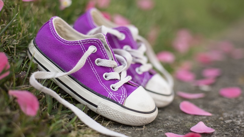 "In My Shoes": purplish little girl shoes with pink rose petals around it. By Emanuele Ravecca.