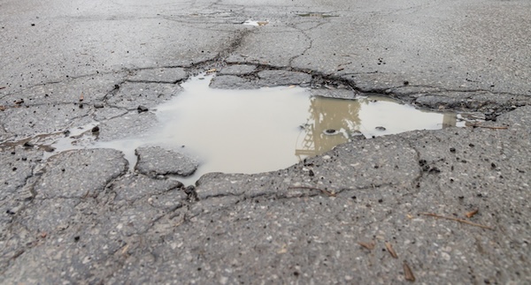 Pothole, by Marc Bruxelle. Used in What's Booming November 26 to promote Controversy/History on Richmond's Aging Infrastructure