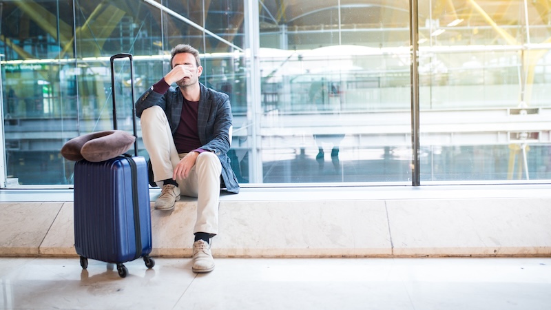 A passenger sitting in an airport, tired as he waits. There are tips to prevent jet lag naturally, before, during, and after your trip to prevent jet lag. (Dreamstime/TCA)