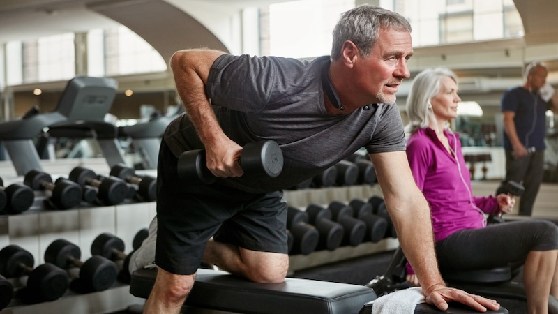 Man lifting weights, hopefully avoiding the mistakes that sabotage your workout (including lifting weights that are too heavy). Image by Yuri Arcurs.