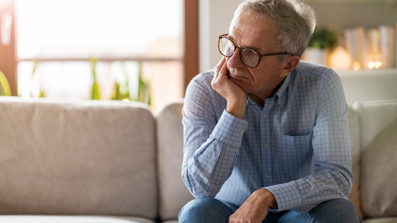 Unhappy man at home, still resentful of toxic employer. Image by Piksel