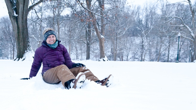 A woman having fun in the snow, a concept of building resiliency - happy despite challenges. By aviahuismanphotography