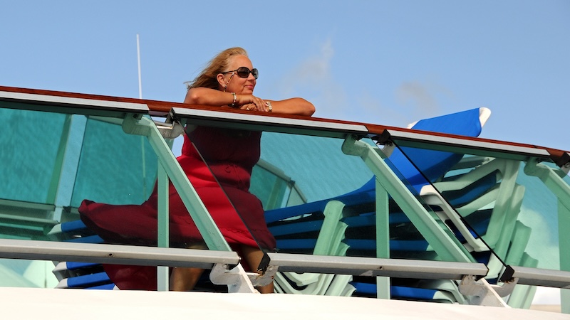 Woman looking peacefully over the rail of a cruise ship, having discovered great trips for solo travelers: You can design a trip that prioritizes your comfort and security. (Dreamstime/TCA)