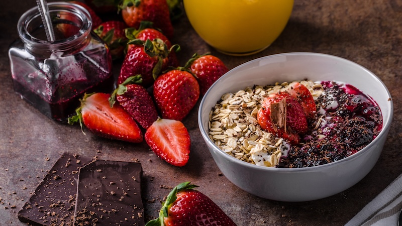 It's good for you to eat more dark chocolate, like with the illustrations of chocolate in a breakfast bowl or chocolate with strawberries. Add dark chocolate to your everyday eating routine without overdoing it. (Dreamstime/TCA)