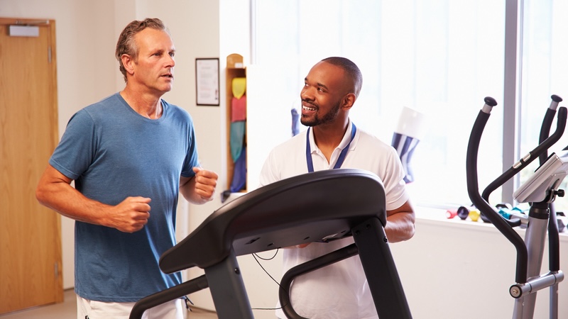 A middle-aged man on a treadmill getting a gait analysis. Monkey Business Images
