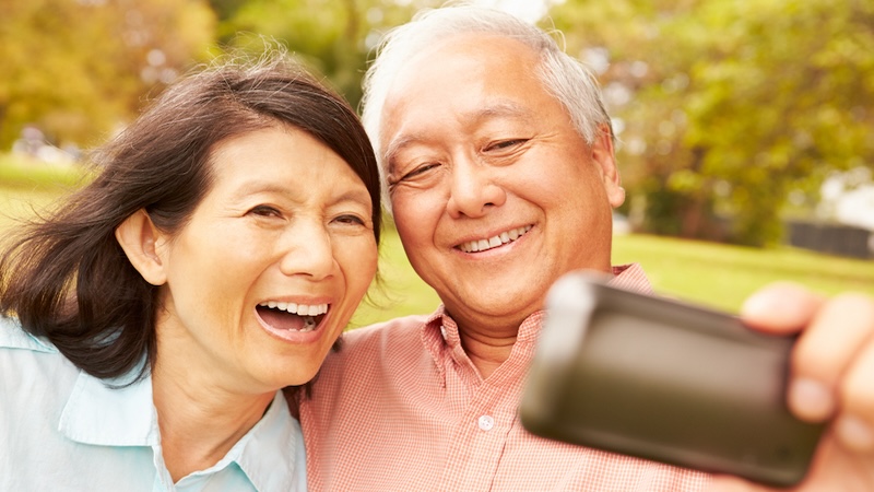 A man and woman taking a selfie - later, the husband is posting unflattering photos of his wife. Image by Monkey Business Images