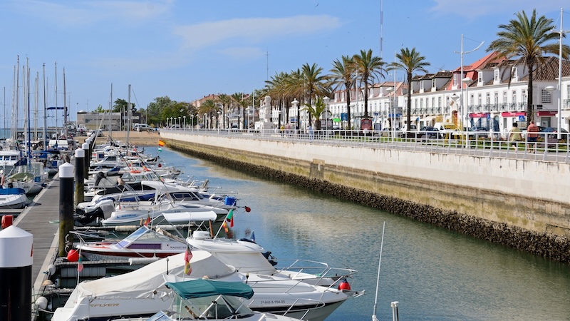 Marina and promenade, Vila Real de Santo Antonio. Yachts and boats moored in the marina with waterfront buildings along the Avenida da Republica to the right hand side, Vila Real de Santo Antonio, Algarve, Portugal.