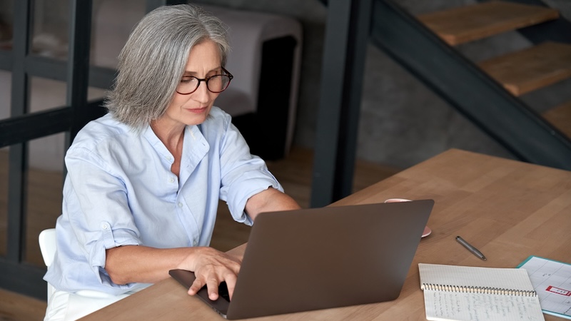 Woman working at a laptop computer, still worthy of employment