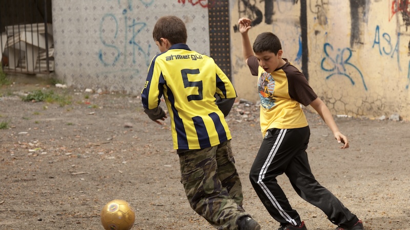 Two European boys play football in an alleyway. Much of Europe’s love for soccer is rooted in accessibility: A pitch can be grass or pavement, a team can be three or thirty, and goals can be a pair of shoes or a line drawn on a wall. If you Europe During the World Cup, the passion can enhance your trip. CREDIT: Dominic Arizona Bonuccelli, Rick Steves’ Europe.