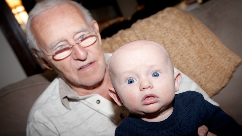 Granddad wants to bond with his grandkids but not hold them - and he looks awkward and the baby surprised. Aviahuismanphotography