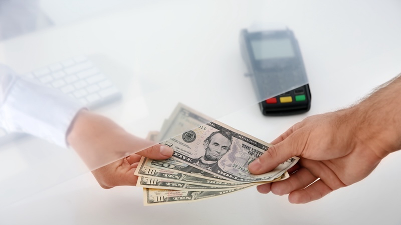 A bank teller handing cash to a customer, but not granting the Chipotle Rule. Chernetskaya