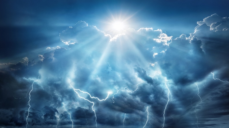 A conceptual image from above the clouds showing the sun and lightning bolts, showing science and religion as allies. By Yevhenii Tryfonov