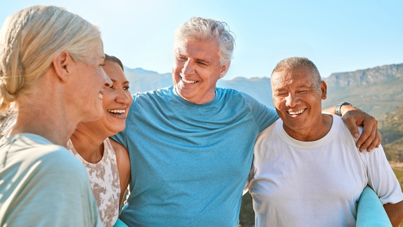 Older adult friends outside, by Yuri Arcurs. Accompanies articles on managing our flaws and intentions as we age.