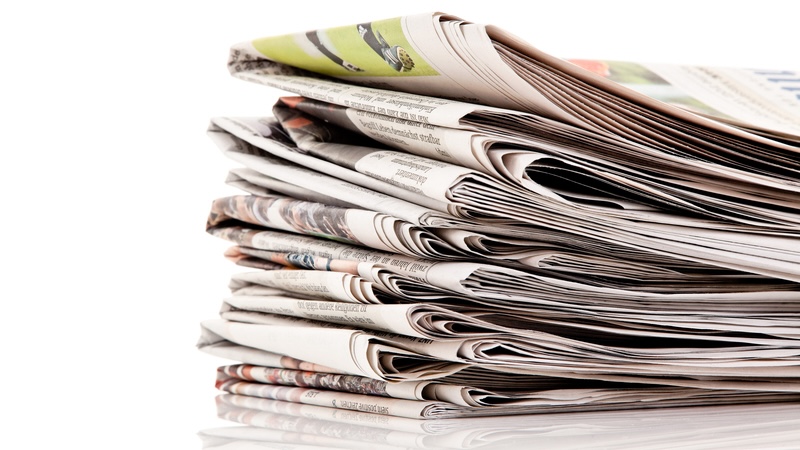 Stack of newspapers, reflecting the essay on memories of the daily newspaper