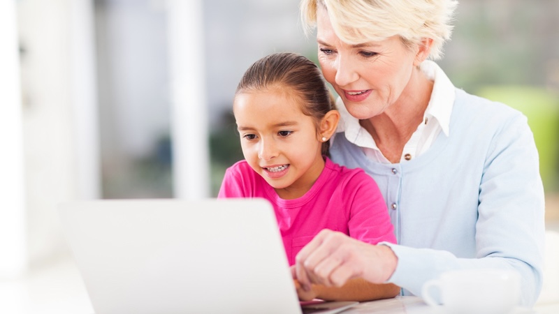 CASA volunteer with a child on computer. Michael Zhang