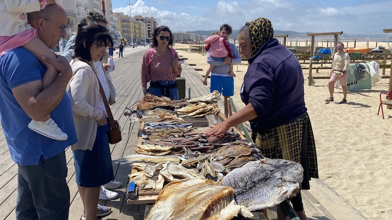 On the Nazaré boardwalk in this old Portuguese fishing town, locals and tourists alike are enticed by vendors offering all sorts of sun-dried and salted fish. CREDIT: Rick Steves, Rick Steves' Europe