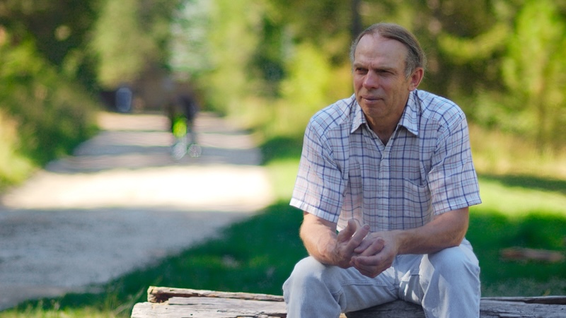 neighbors are rude to a man with autism so he's sad as he sits outside on a fallen log. Ben Bibikov