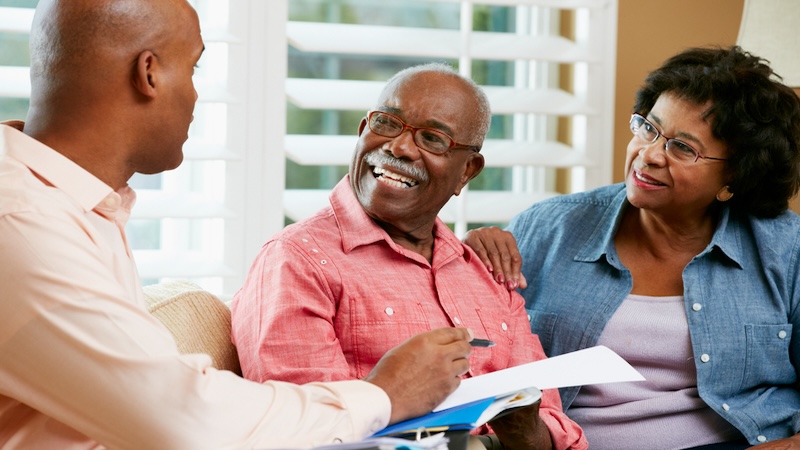 A couple with a financial planner creating their forever paycheck. Monkey Business Images.